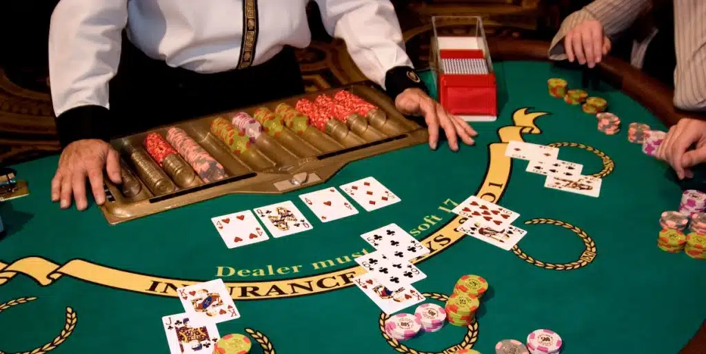 Blackjack table at the casino showing face up cards and chips