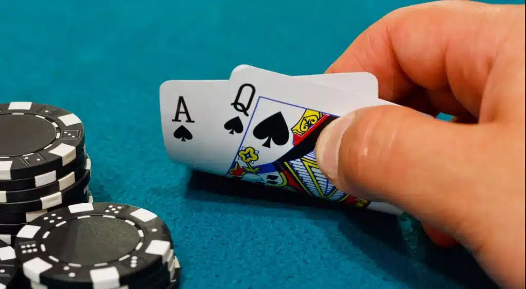 Player looks at cards totaling 21 in a game of pontoon