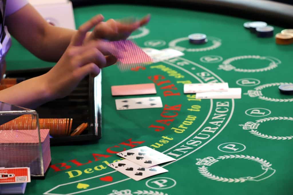 A croupier deals cards at the blackjack table