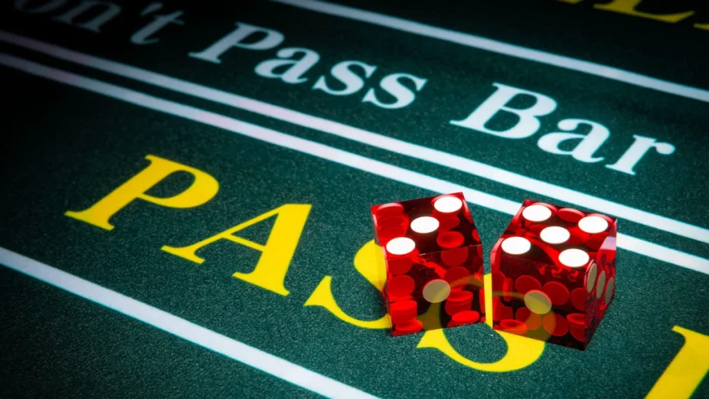 Pass Line area on a craps table Two red dice resting on the Pass Line area of a craps table.